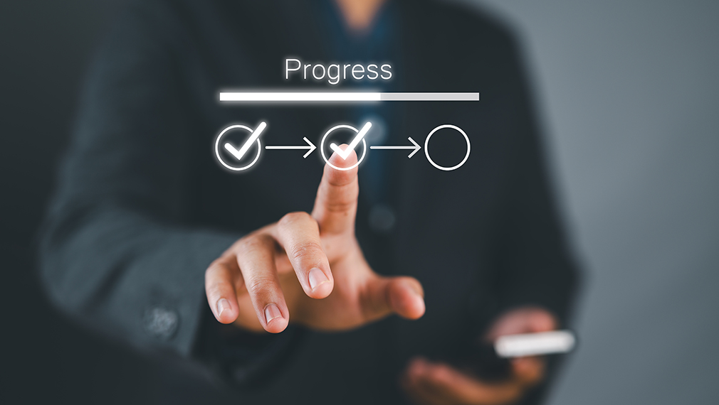 Person using a laptop to track exemption status online.